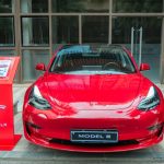 Tesla Model 3 electric car parked on a Portuguese street