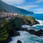 Aerial view of Madeira island coastline and hillside towns