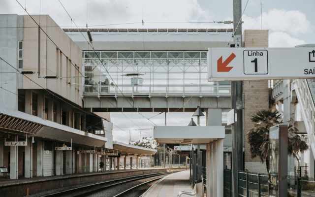 Intercidades train at a Portuguese station platform in summer