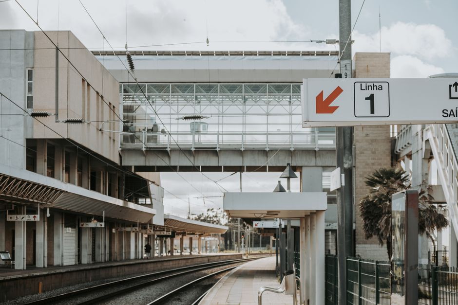 Intercidades train at a Portuguese station platform in summer