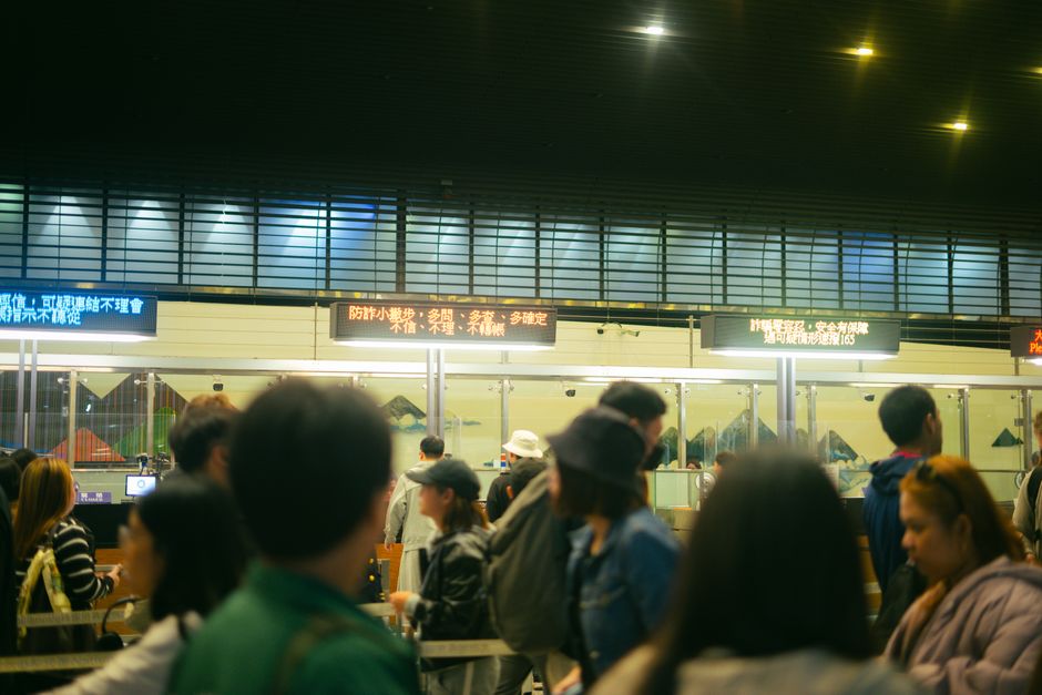 Travellers queuing at an airport border control checkpoint
