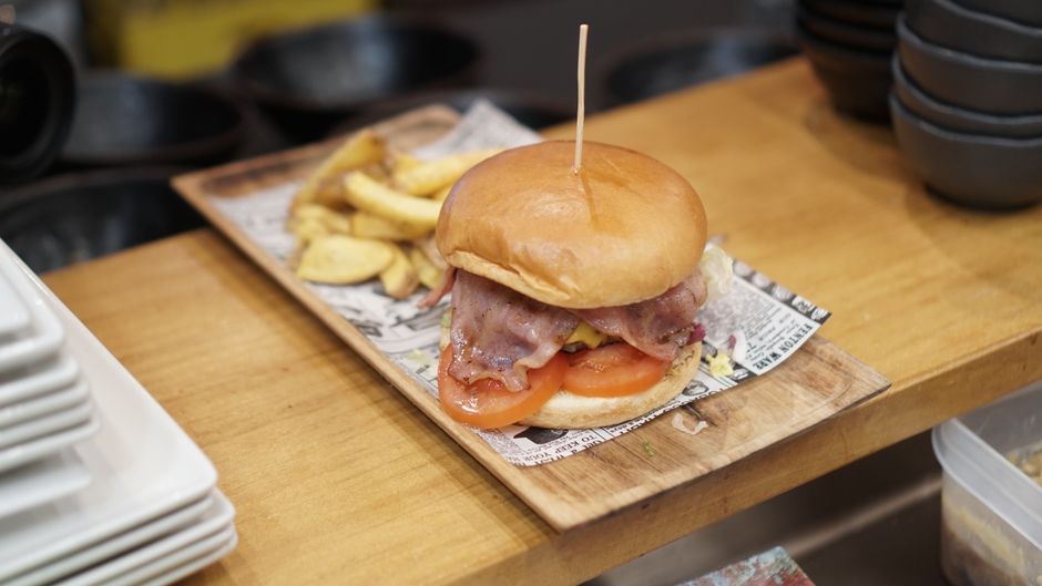 Plate of American-style burger and fries on restaurant table