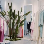 Interior of a boutique clothing shop with racks of garments