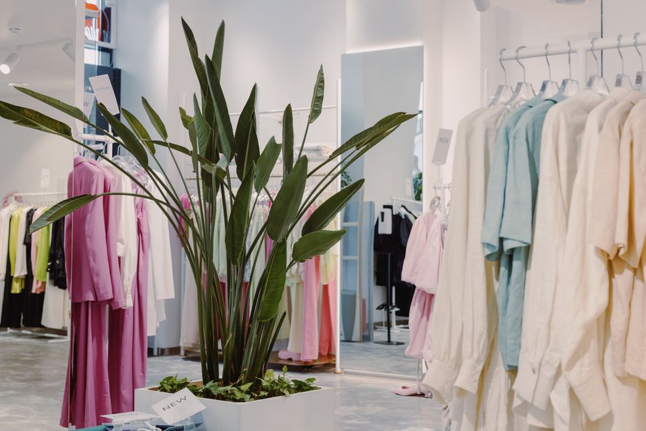 Interior of a boutique clothing shop with racks of garments
