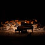 Pianist performing on stage during outdoor summer festival