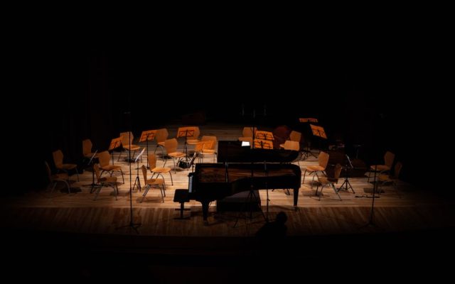 Pianist performing on stage during outdoor summer festival
