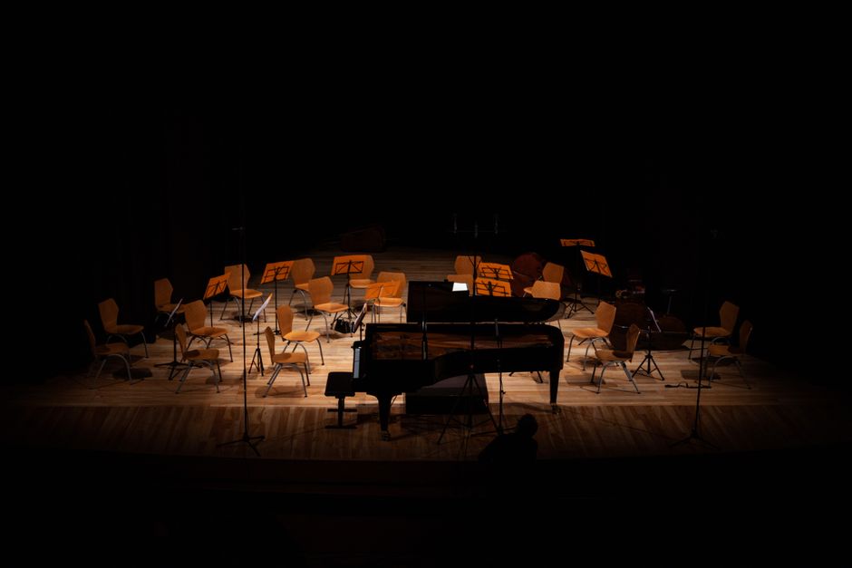 Pianist performing on stage during outdoor summer festival