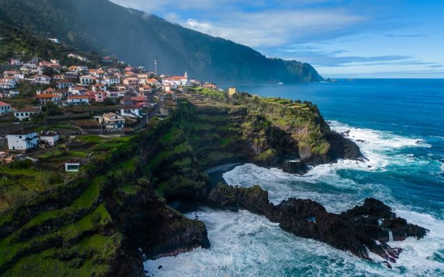 Aerial view of Madeira island coastline and hillside towns