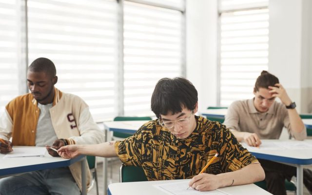 Students checking university admission results on a screen