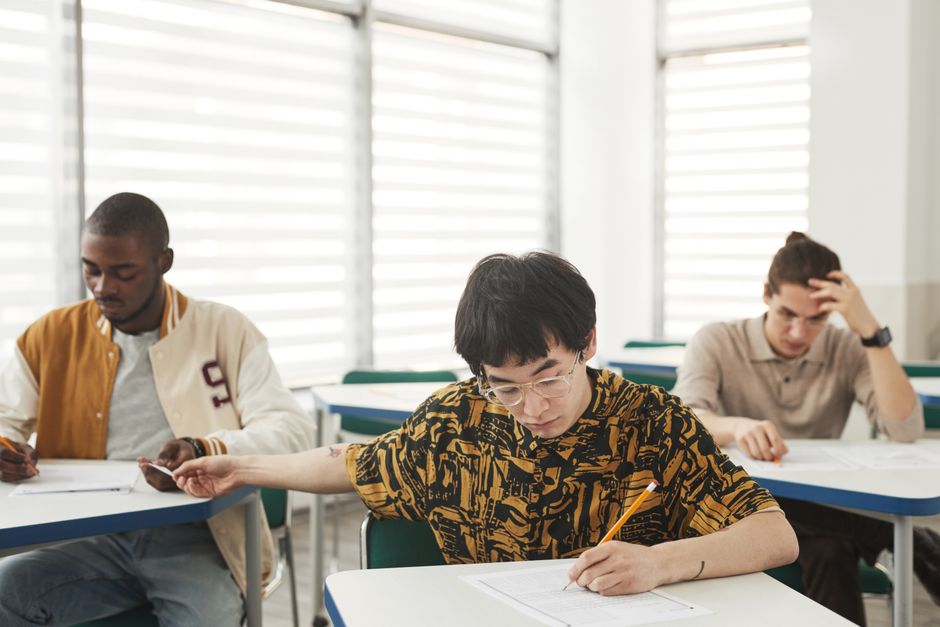 Students checking university admission results on a screen