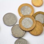 Person reviewing Portuguese Treasury savings certificate paperwork